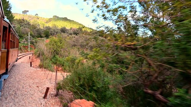 Historic train ride from Palma Mallorca to Soller town view from the train to the landscape woman