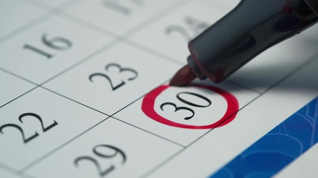Red marker circling day 30 on calendar, planning event, important date marked, close-up