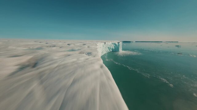 FPV drone flying along Nordauslandet glacier edge in Svalbard Arctic