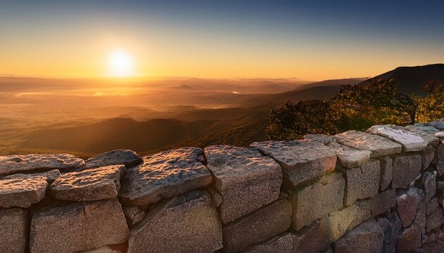 Stone Wall Fragment With Distant Landscape At Sunrise
