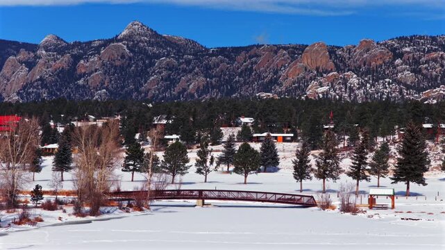 Lake Estes Park walking bridge Lumpy Ridge Twin Sisters winter snow morning sunny blue sky aerial drone Colorado Front Range Rocky Mountain National Park RMNP Continental Divide Larimer County circle