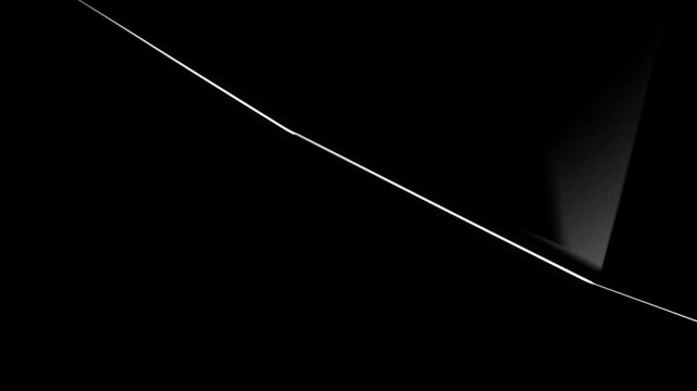 Abstract composition featuring a sharp diagonal light line cutting across a deep black background creating a minimalist high contrast geometric design with dramatic negative space