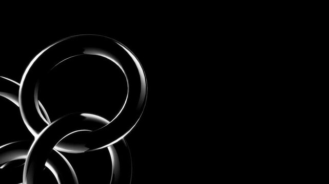 Cluster of glossy black metallic interlocking rings forming an abstract geometric shape on a deep black background with smooth reflections and dramatic lighting