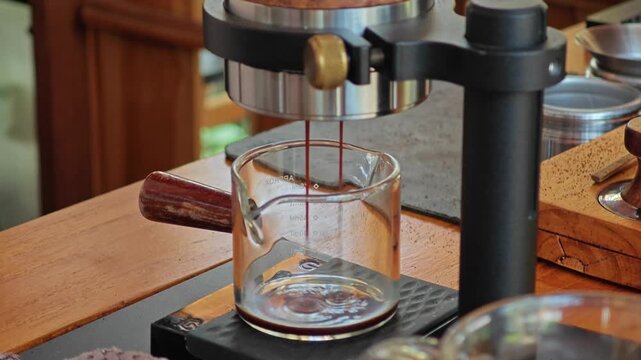 Manual espresso maker making brewed coffee.