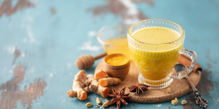 Golden Cinnamon  Turmeric Milk. Trendy hot Healthy drink with turmeric roots and spices. Indian Masala Haldi Doodh.