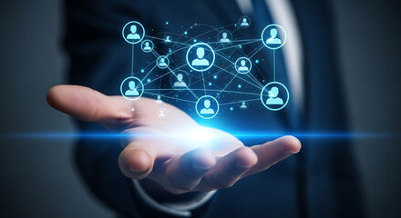 Fototapeta premium A hand holding a glowing network of people icons, representing connection and social networking in business and technology
