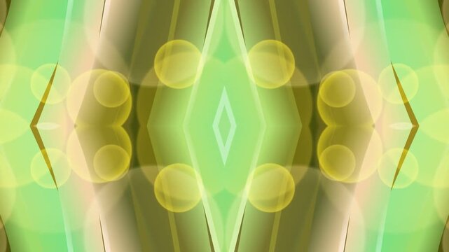 Symmetrical abstract shapes in shades of green and yellow, forming a geometric pattern with circles and diamonds, creating a sense of balance and harmony, viewed from a straight-on perspective.