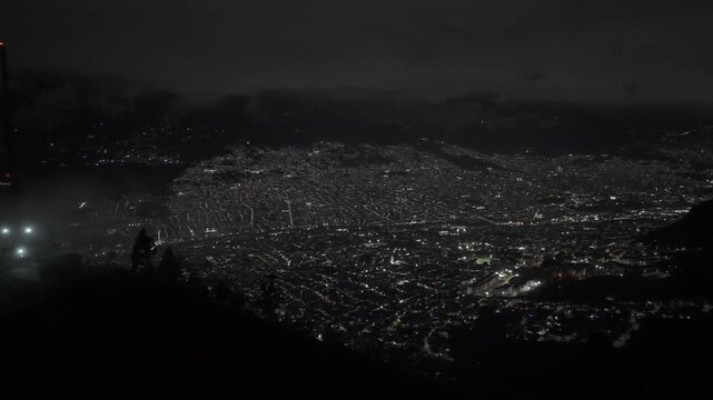 Cinematic aerial views of Medellin, Colombia captured from a scenic viewpoint overlooking the city. The footage showcases the urban landscape surrounded by green mountains in the Aburr&aacute; Valley, highli