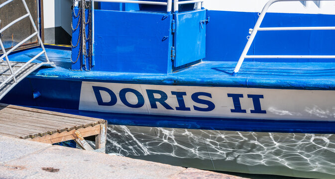 Helsinki, Finland - August 07 2025: Blue and white passenger boat named Doris II at dock.