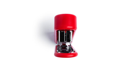 Red stapler on a white background. High quality photo