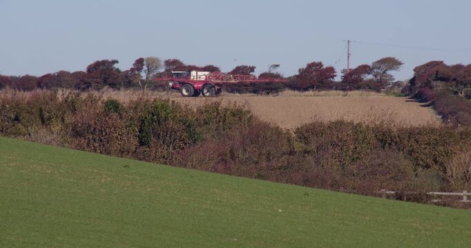 Tractor crop spraying in a field