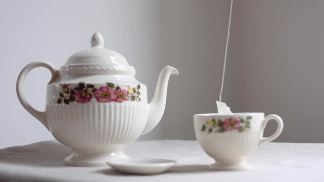 Video of teabag going in an antique cup.