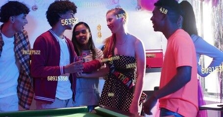 Smiling celebrant wearing strapless dress with birthday sash posing at party by green pool table