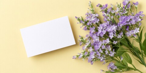 a blank card on a yellow background with flowers.