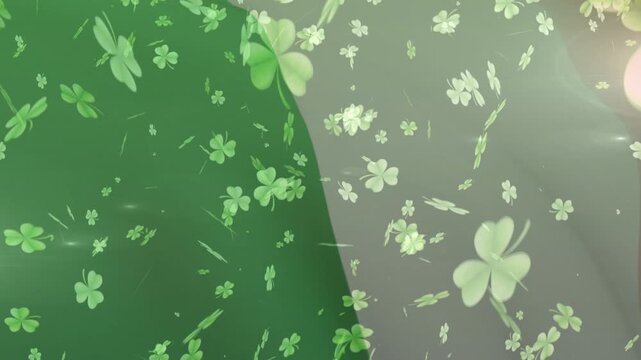 Soft breeze starting, clover shapes drifting and rotating across two-tone panels, creating flow