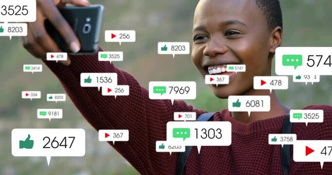 Woman taking selfie, checking phone as animated likes or comments multiplying for social media