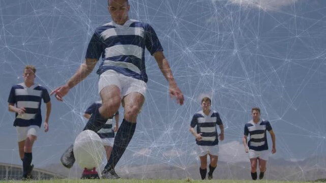 Five players running toward cam, central kicker planting foot, kicking for sports, overlay on tee