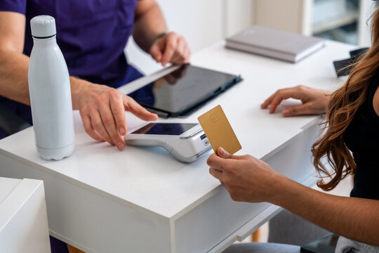 Patient paying for medical physiotherapy treatment using credit card