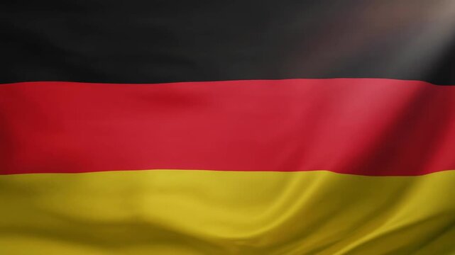 A vertically striped flag, the fabric billowing gently. The top band is black, followed by red, and lastly, a yellow band at the bottom