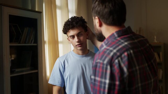 Father talking with his adolescent son, teaching him values and responsibility