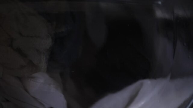 Striped Shirt Spinning Inside Washing Machine Drum During Color Test Laundromatstyle Tension With Cautionary Dye Tones, Suds And Motion Highlighting Pattern And Texture While Attendant