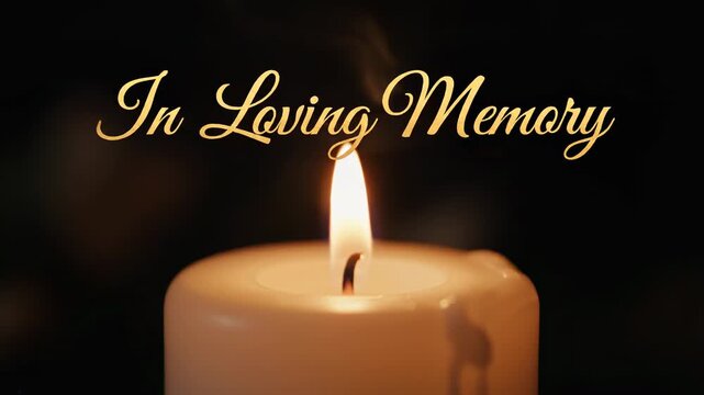 A lit candle against a dark background, with the phrase "In Loving Memory" written above in gold script