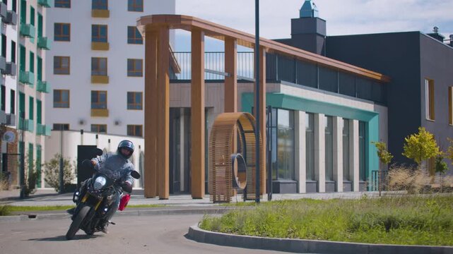 A motorcyclist taking a banked turn. Watch a motorcyclist navigate a sharp banked turn with smooth balance and confident handling.