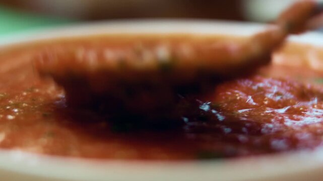 Stirring the freshly made salsa sauce using a spoon