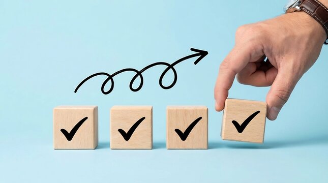 A single human hand places a wooden block marked with a check symbol next to three established blocks, indicating final completion or goal achievement.