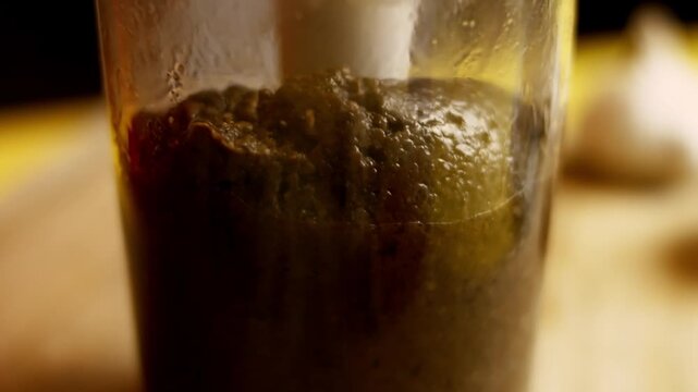Using a blender to puree the sauteed mushrooms with spices