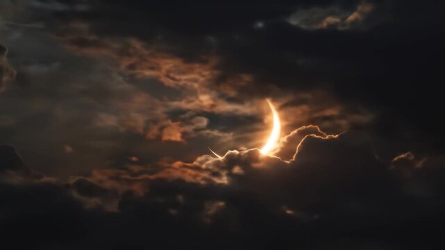 Dramatic partial solar eclipse seen through a dramatic cloudy sky.