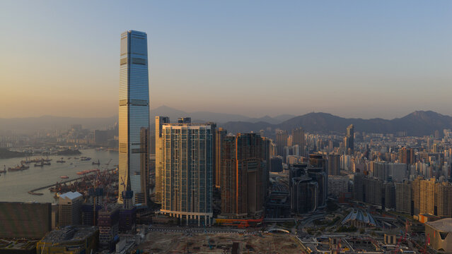 Hong Kong, Hong Kong - 13 February 2026: Aerial view of the city's skyline where the International Commerce Centre pierces the sky, its glass facade reflecting the soft light of the setting sun.