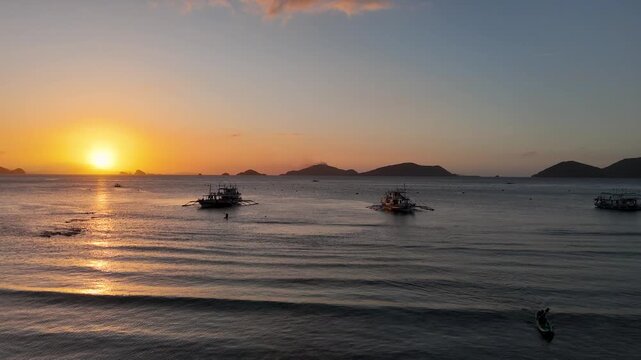 Drone aerial view of KMAAL campsite at sunset in Linapacan near Coron in The Philippines.