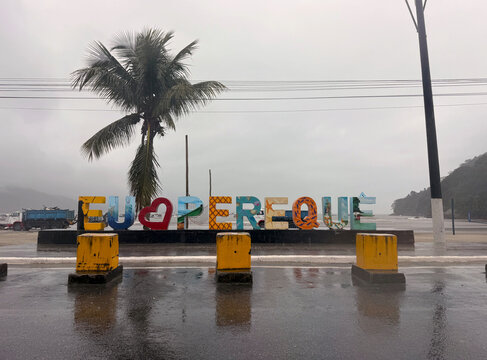 Lettering at Pereque beach at Brazilian city of Guaruja on a cloudy rainy spring day.  Photo taken October 10th, 2025, Pereque, Guaruja, Brazil.