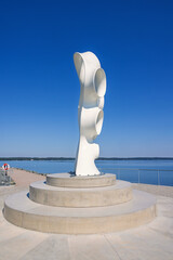 Fototapeta premium Modern artwork on a pier with a view at a lake a sunny summer day