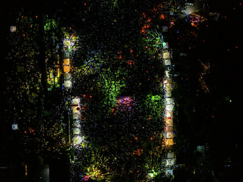 Aerial view of a sea of lights at Parangtritis Lantern Festival, with vibrant colors illuminating the night sky, Yogyakarta, Special Region of Yogyakarta, Indonesia.