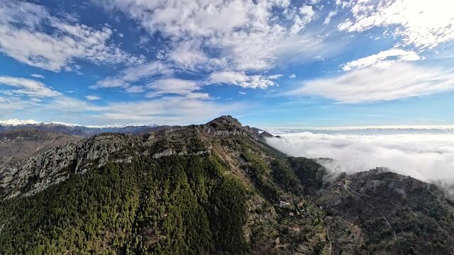 Aerial view of mountain ridge above sea of clouds in the French Riviera hinterland