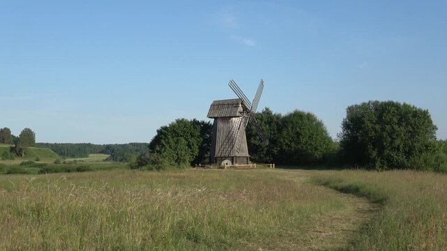 View of an old wooden windmill on a June day. Mikhailovskoe. Pushkin Mountains, Russia