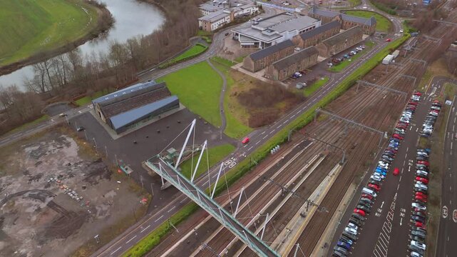 Stirling Scotland city skyline drone flyover and mountains in the distance. Clouds cover the sky, creating an atmosphere in the Scottish highlands