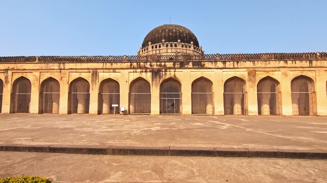 Solah Khamba masjid with garden trees and sky in bidar fort at karnataka, india. day time, push in shot, 4k.