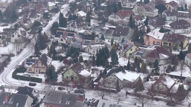 Svitavy town in winter from above, snowy houses and families area.
Drone view of quiet neighborhood under snow.