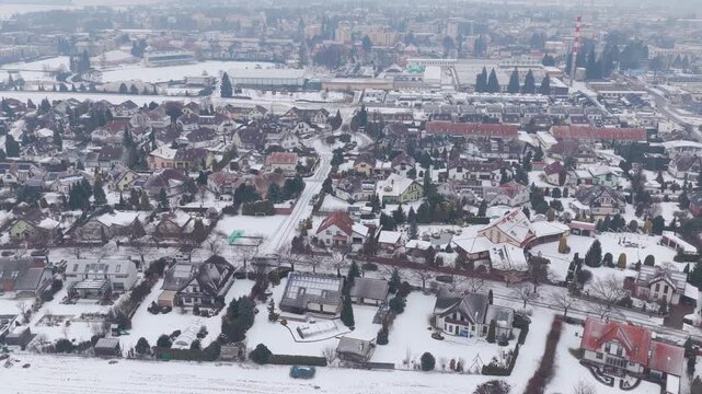 Drone view of Svitavy in winter with snowy houses and streets.
Calm neighborhood scene in cold season.