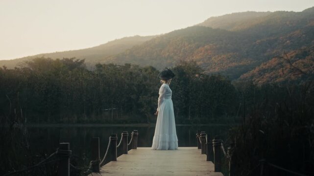 Elegant Tranquil Scene. Peaceful Depiction Of Woman Standing On Bridge As Evening Sky Transforms