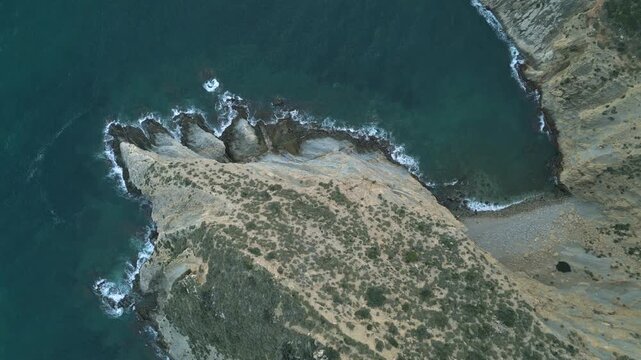 Aerial top-down view of a rocky cape and seashore