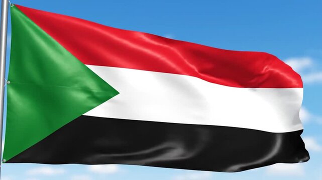 Flag of Sudan waving proudly in the wind against a clear blue sky background.