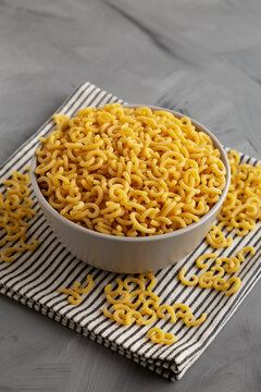 Organic Raw Dry Gramigna Pasta Ready to Cook in a Bowl, side view.