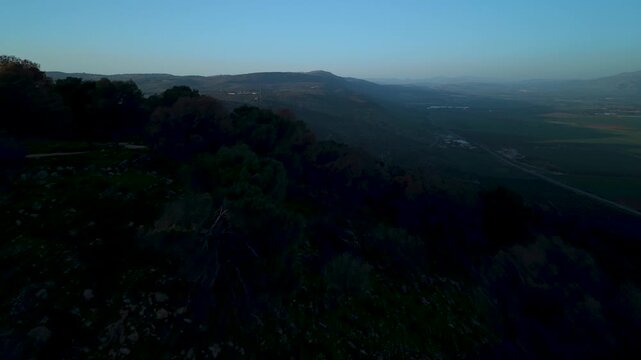 Nabi Yusha Forest and Ramim Ridge overlooking Ramot Naftali and Hula Valley during golden hour light in northern Israel.