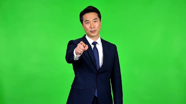 Ultra realistic professional businessperson in formal suit presenting and pointing forward in front of evenly lit pure green screen background (#00FF00), natural body movement, confident gestures