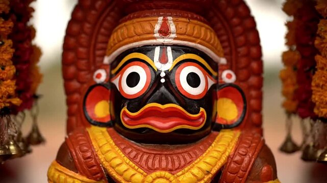 Vibrant Jagannath Statue Celebrated Amid Ornate Headdress and Floral Accents in Sacred Temple Setting