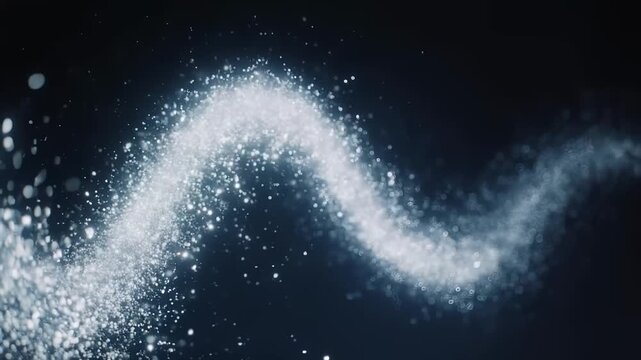 A twisting stream of bright particles sweeps across a dark background, sparkling like dust in motion, with a soft glow and bokeh flecks fading into shadow along the sinuous path.